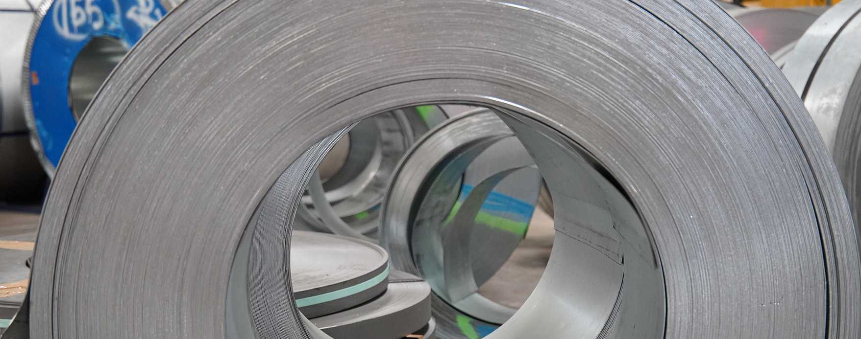Photo of a large roll of metal used for plate manufacturing.